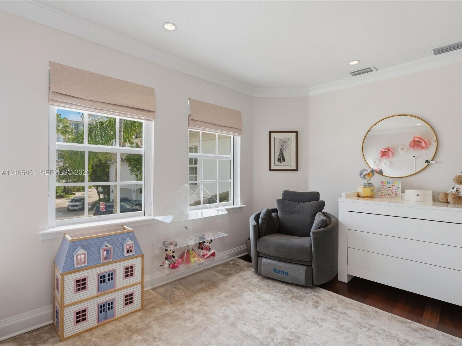 Neutral-toned room featuring crown molding, recessed lighting, grid-pattern windows, and dark-toned flooring