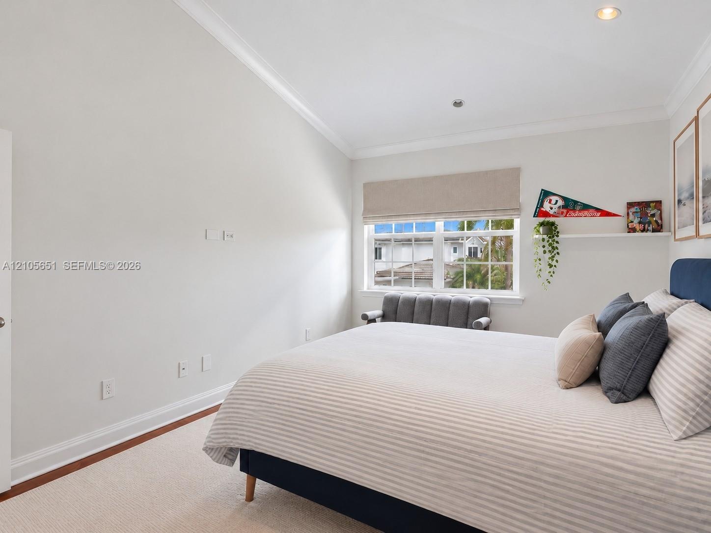 Vaulted ceilings featuring recessed lighting, crown molding, neutral carpeting, and a double-hung window with an integrated blind