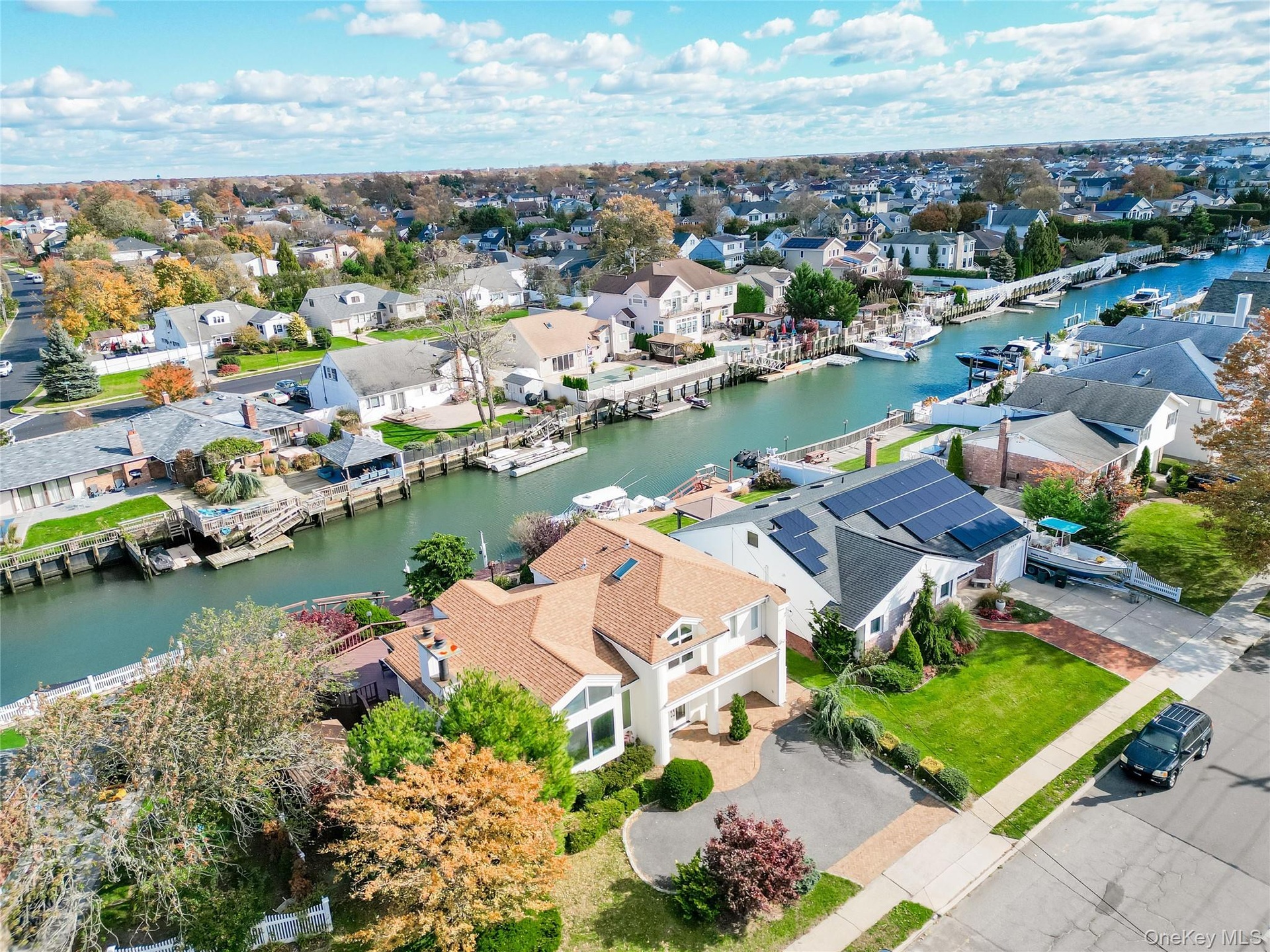 Aerial view of residential area featuring a nearby body of water