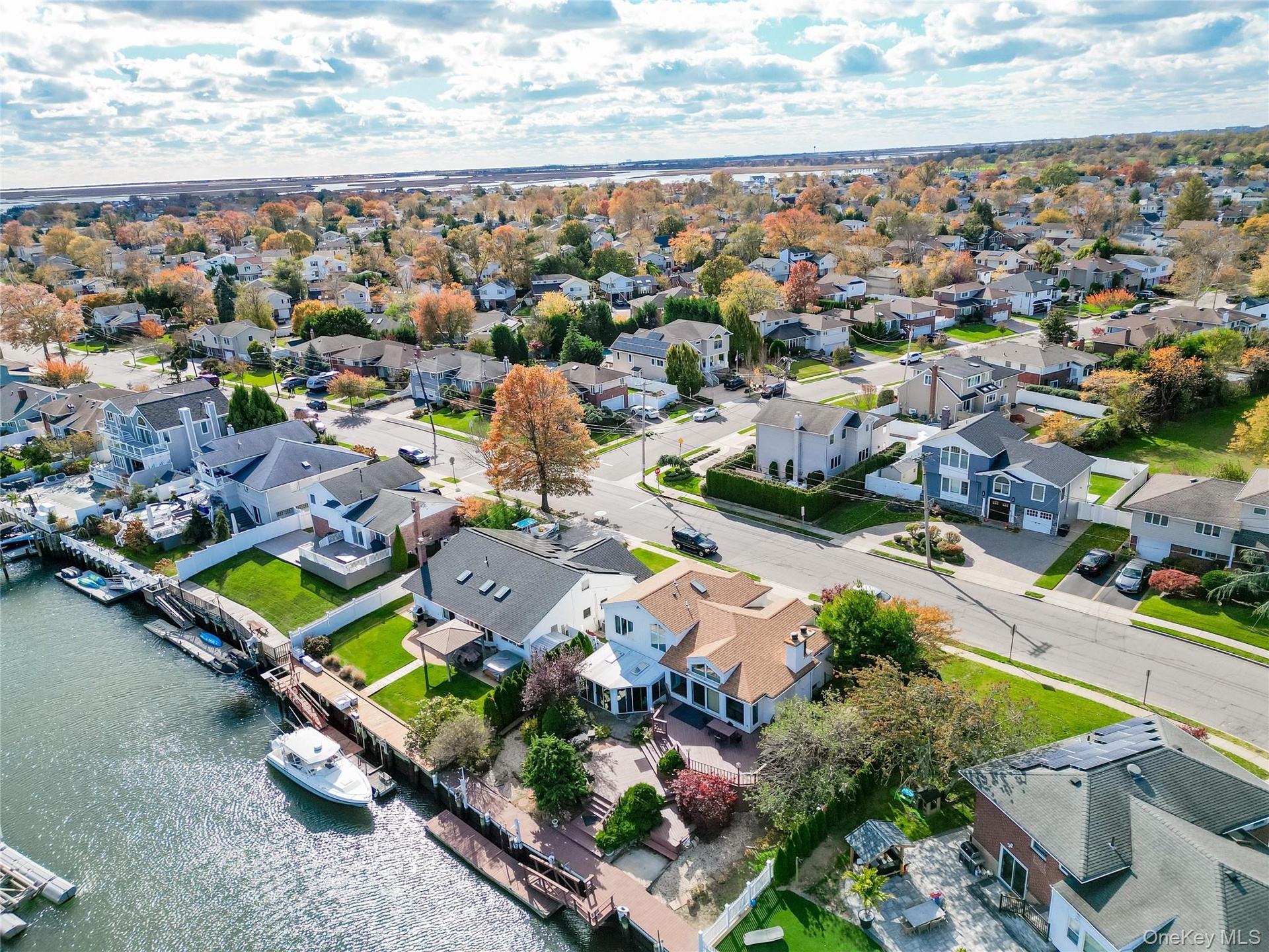 Aerial perspective of suburban area featuring a large body of water