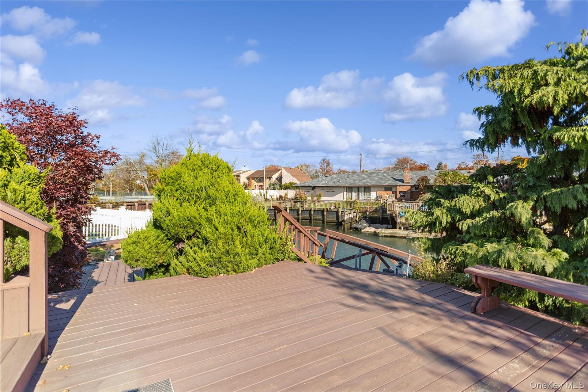 Wooden terrace with a water view and a boat dock