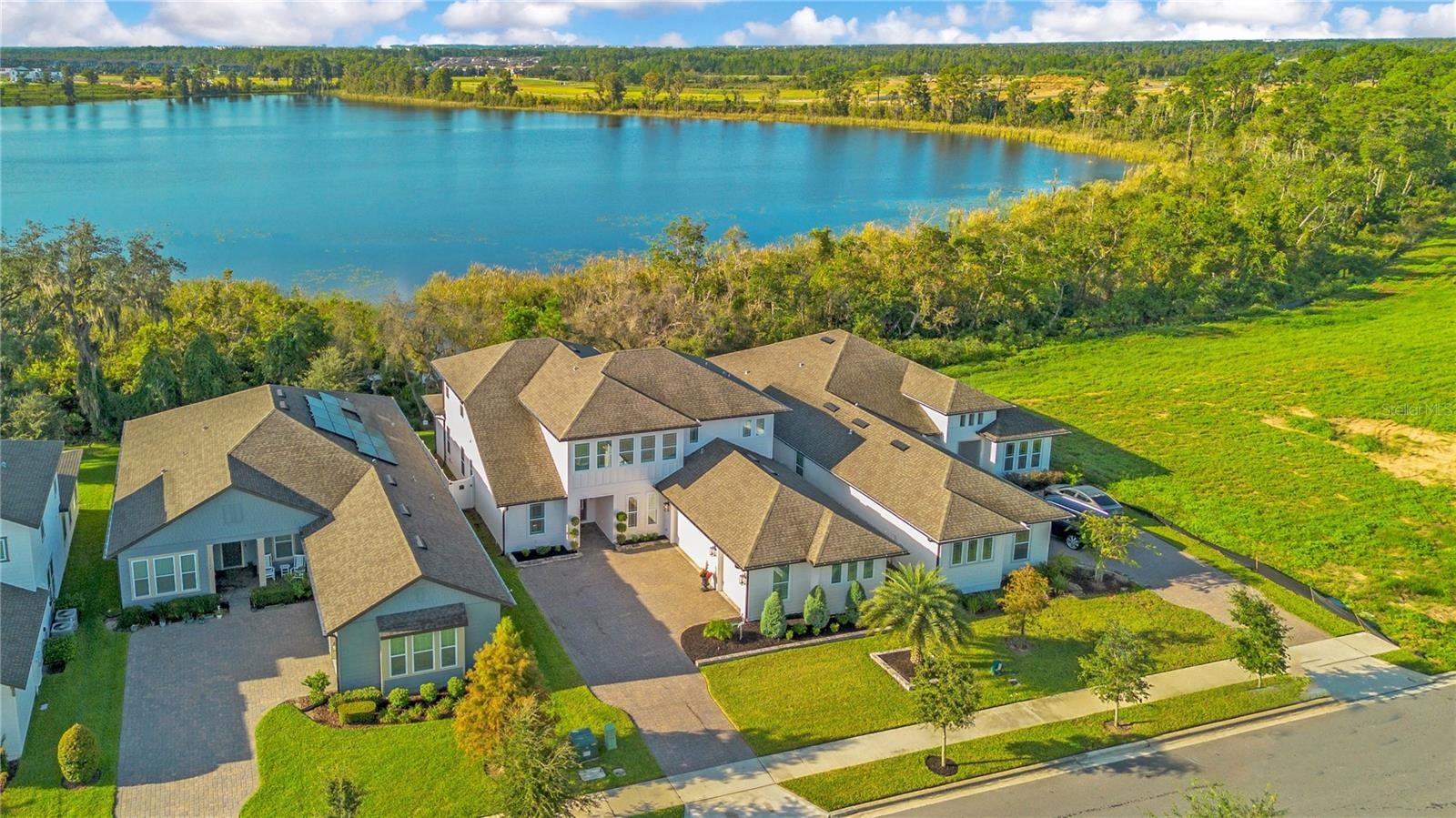 Lake views framed by mature trees and natural landscaping along the backyard.