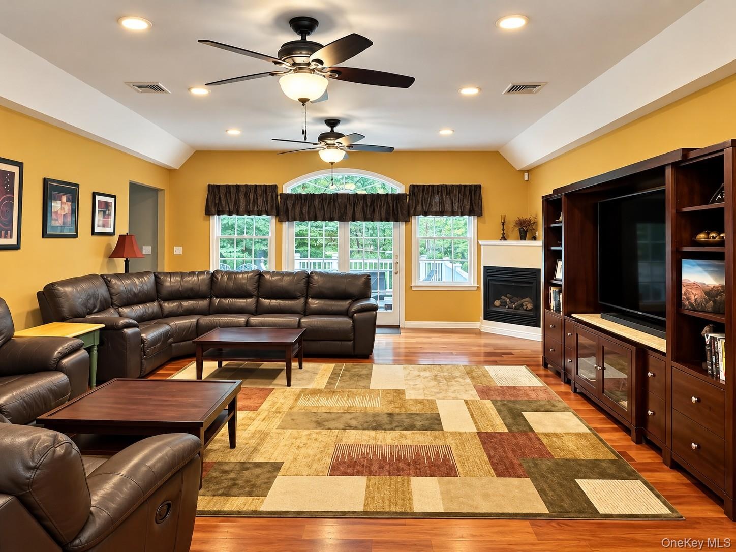 Family Room with wood floors, recessed lighting propane fireplace -