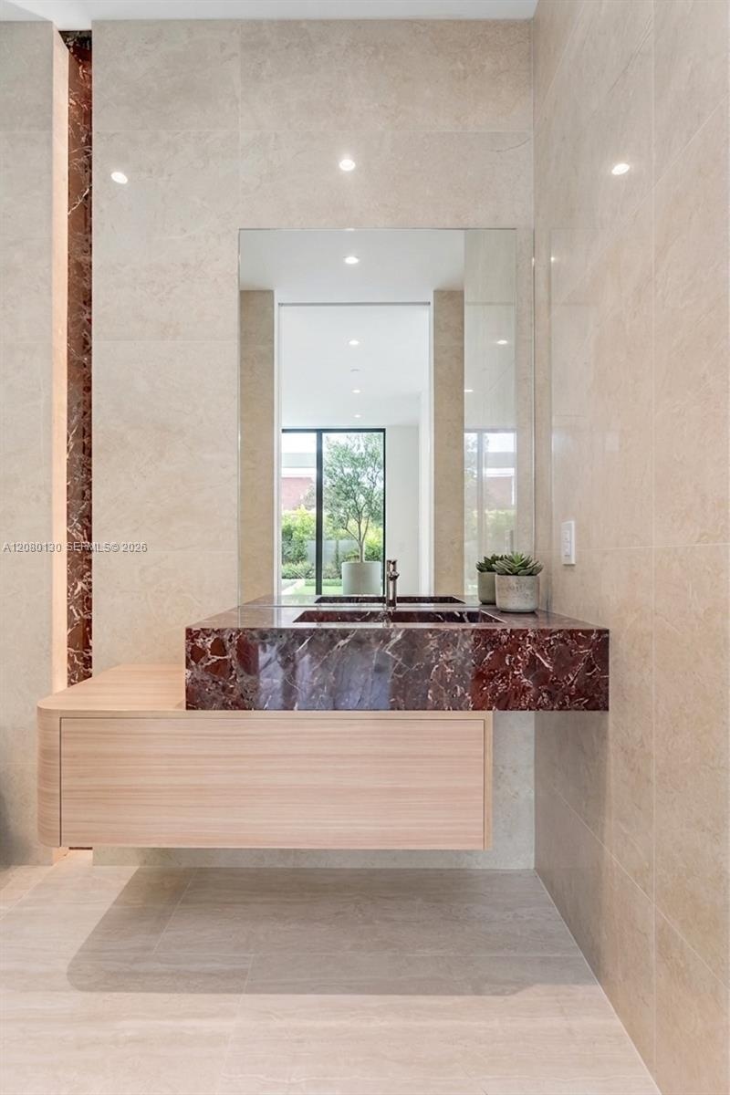 Guest Bathroom. Disclaimer: Several photographs presented in this listing contain digitally added furniture, artwork, and decor. These virtually stage