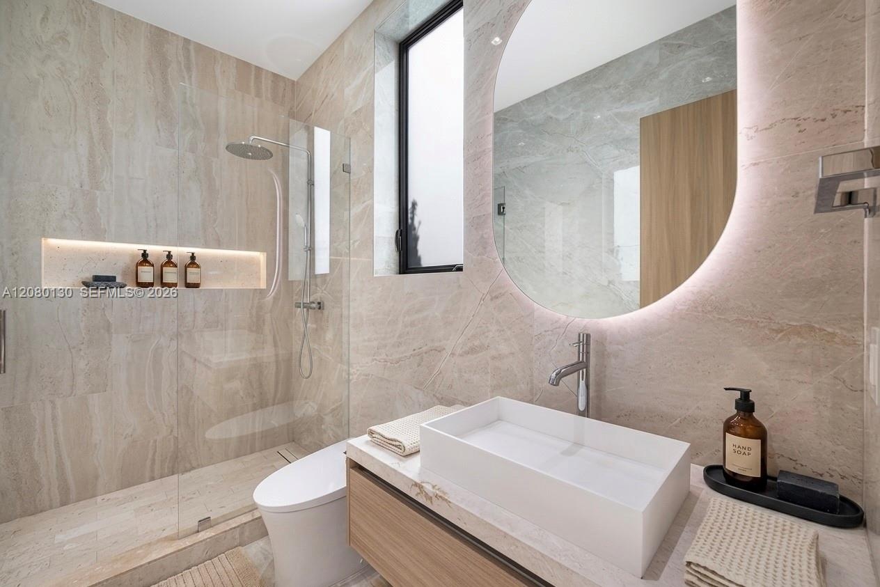 Guest Bathroom. Disclaimer: Several photographs presented in this listing contain digitally added furniture, artwork, and decor. These virtually stage