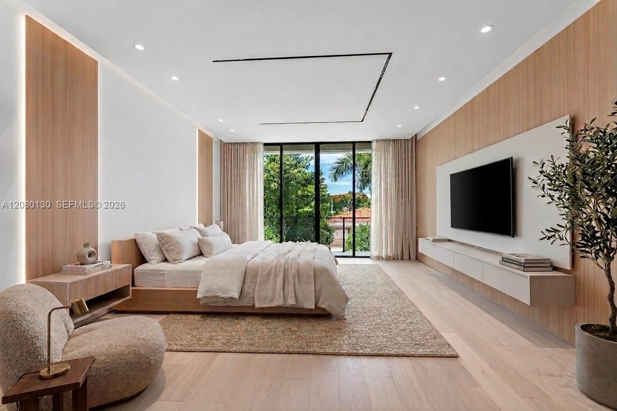 Primary Bedroom. Disclaimer: Several photographs presented in this listing contain digitally added furniture, artwork, and decor. These virtually stag