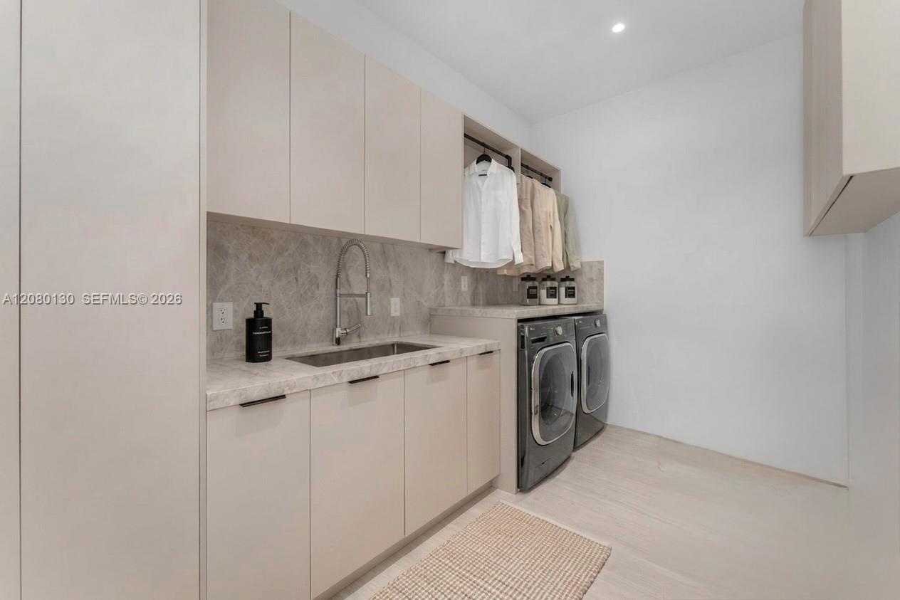 Laudry Room. Disclaimer: Several photographs presented in this listing contain digitally added furniture, artwork, and decor. These virtually staged i