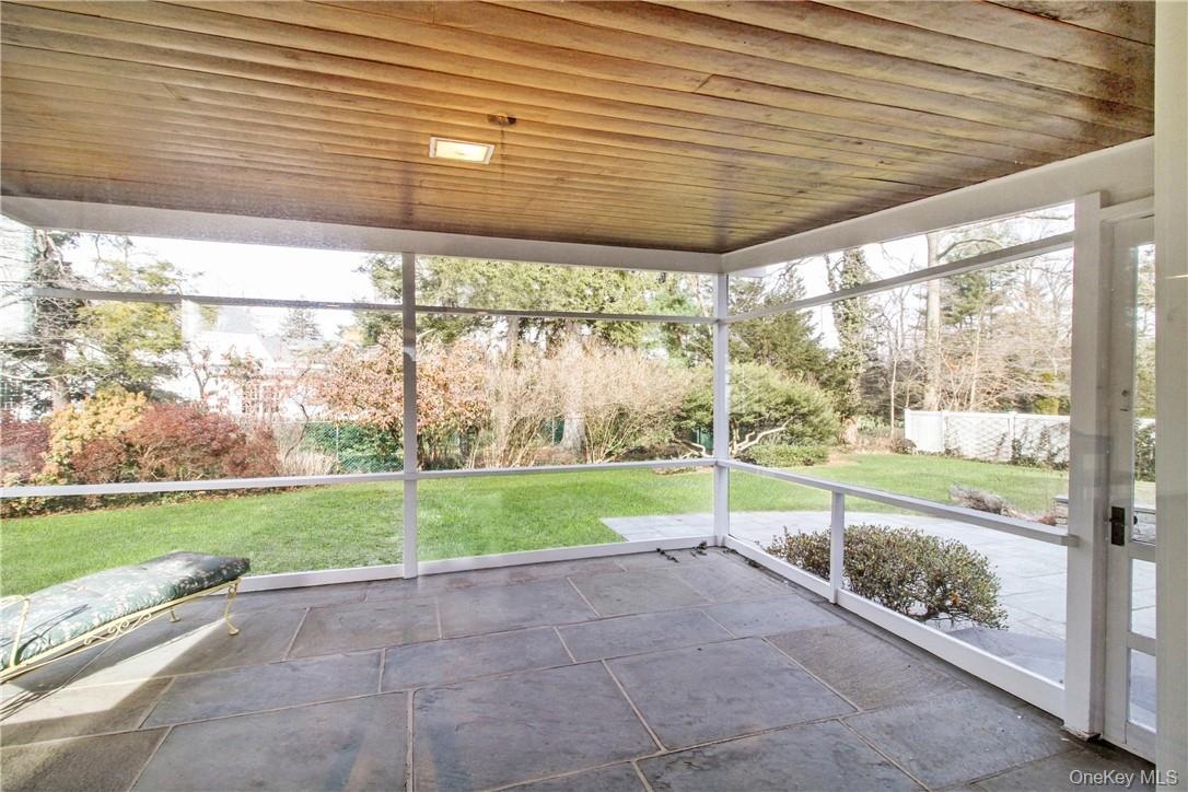 Covered screened porch accessed from great room and opening to yard. Photos taken when house was empty prior to occupancy.