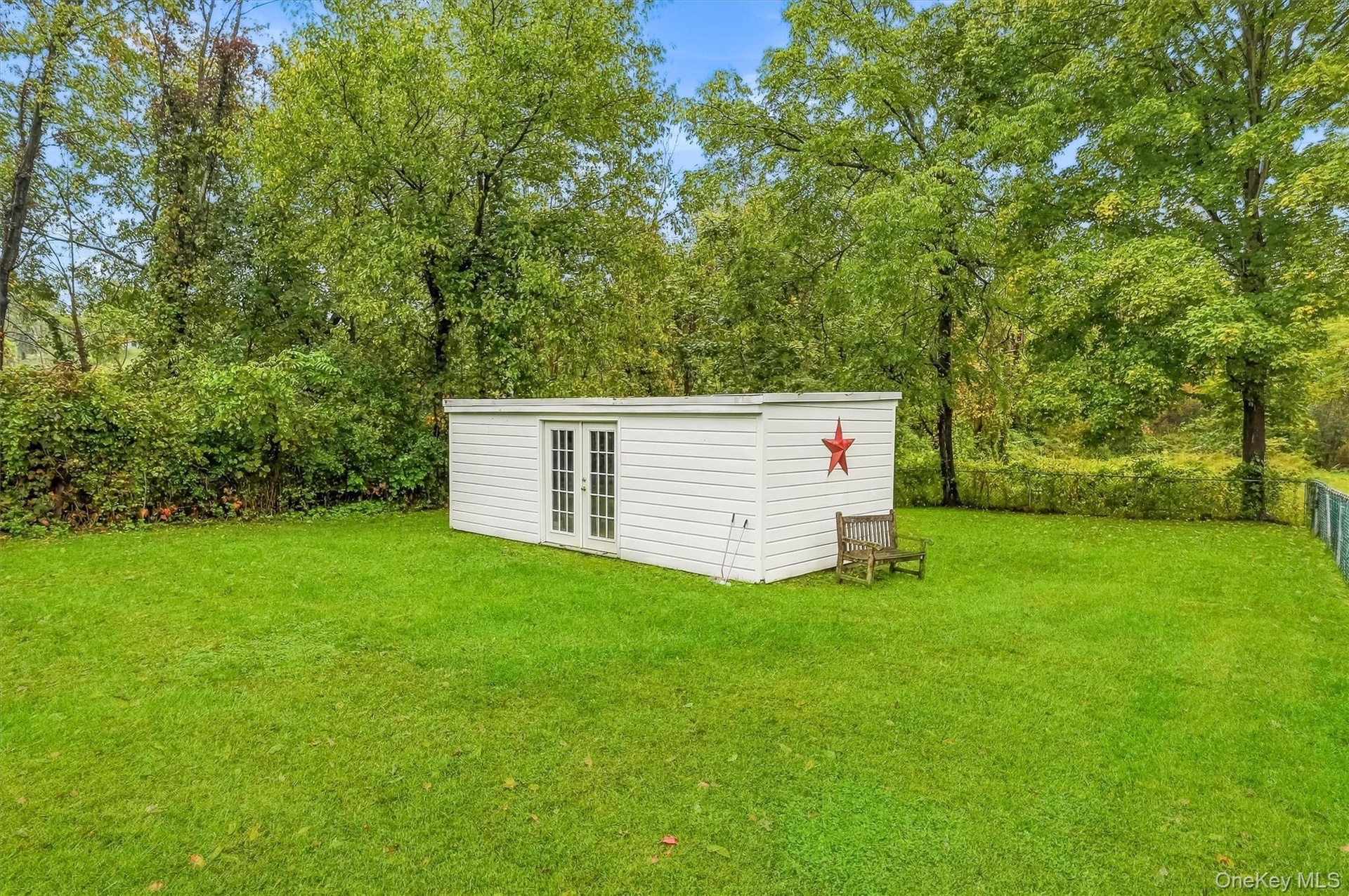 Fenced dog run with oversized shed, previously used as a chicken coup