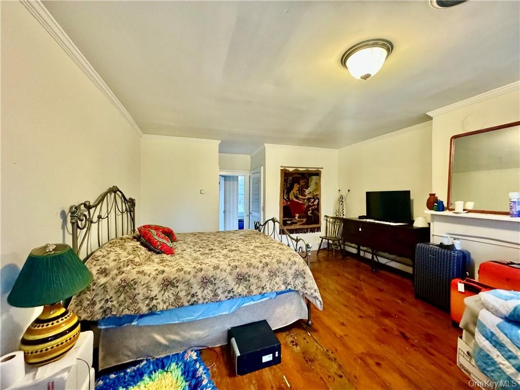 2nd floor Master Bedroom featuring ornamental molding and dark hardwood / wood-style floors