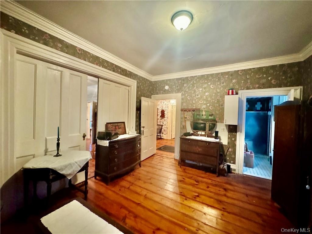 1st floor Bedroom featuring ornamental molding and wood-type flooring