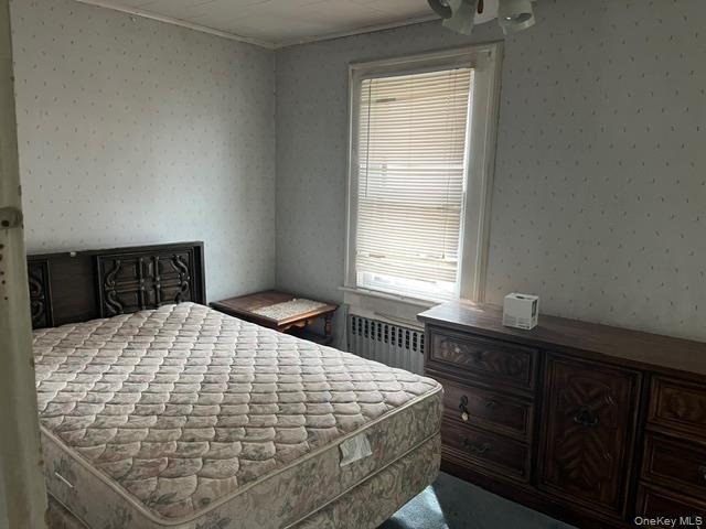 Bedroom with radiator heating unit