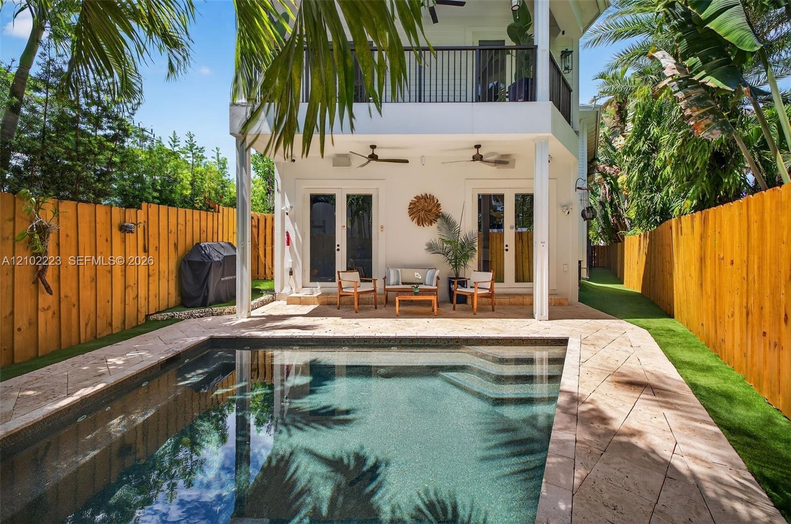 Your own slice of tropical paradise designed for effortless enjoyment and minimal maintenance. This charming outdoor oasis features a heated saltwater