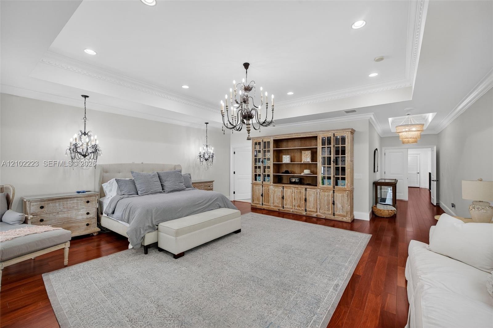 Another perspective of this extraordinary primary suite reveals its remarkable scale and versatility with room for a king size bed, a substantial sitt