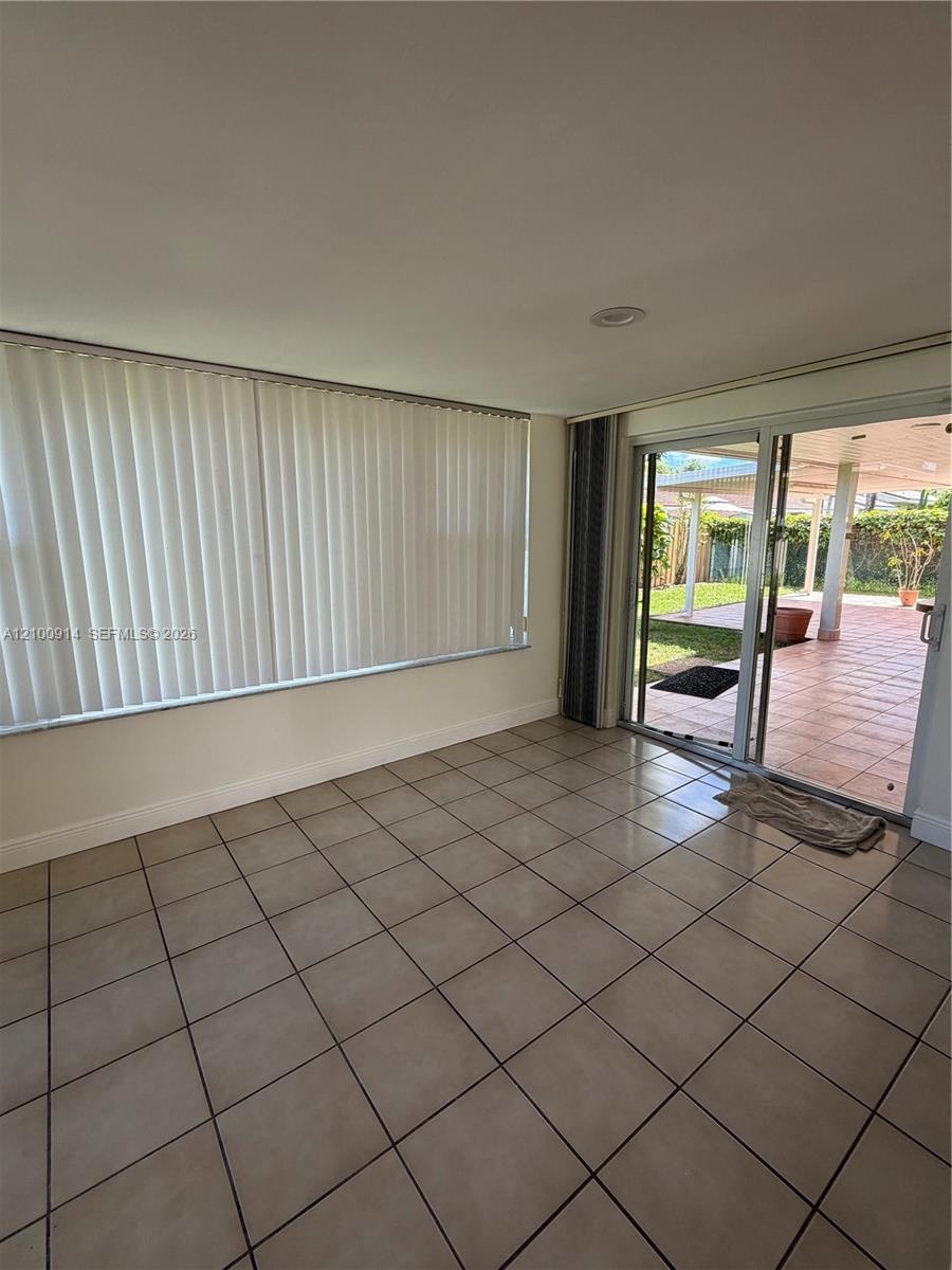 Tile flooring, recessed lighting, and expansive wall-to-wall windows