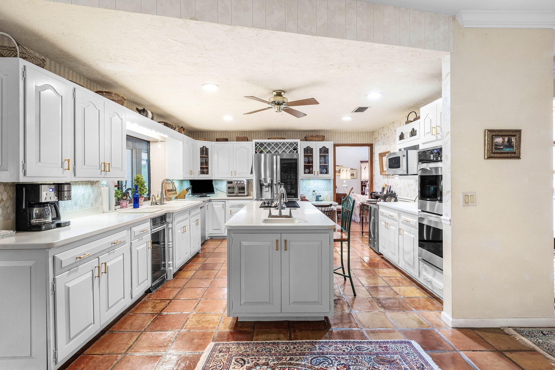 Kitchen featuring center island w/ prep sink & double oven