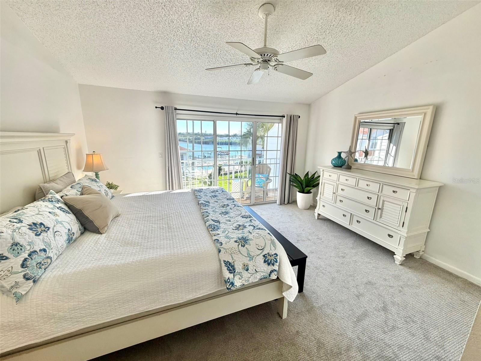 Primary Suite on the Upper Level With Waterview from Private Deck.