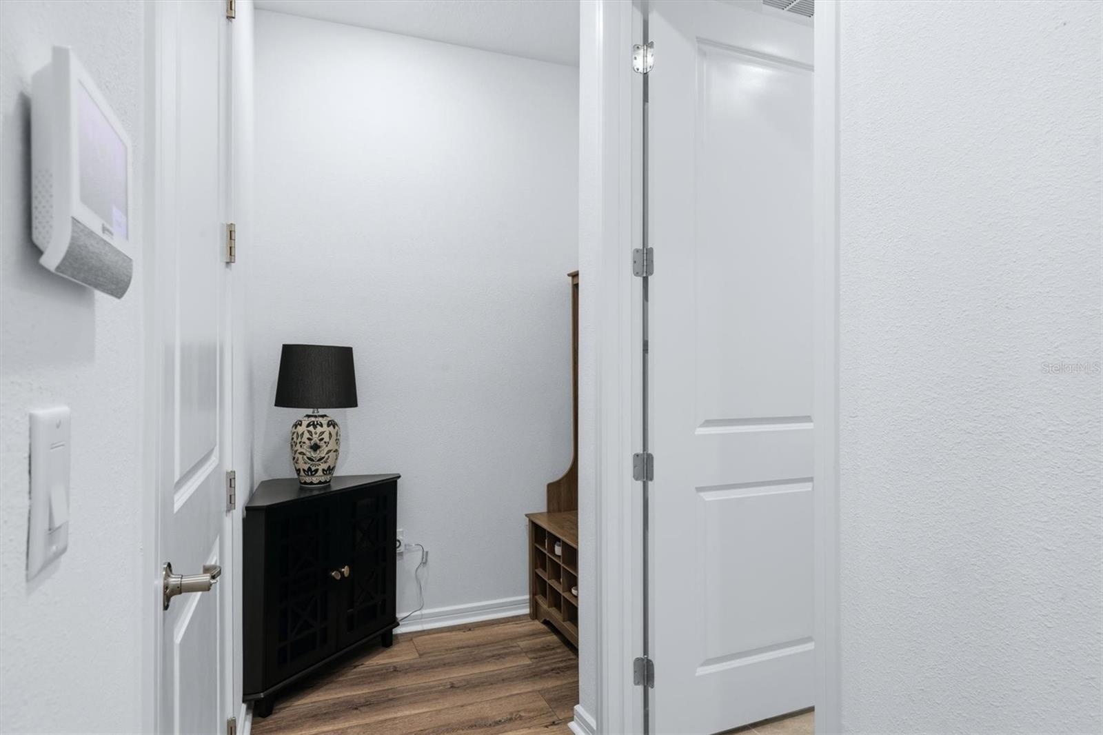 A mudroom area tucked away inside garage door entry