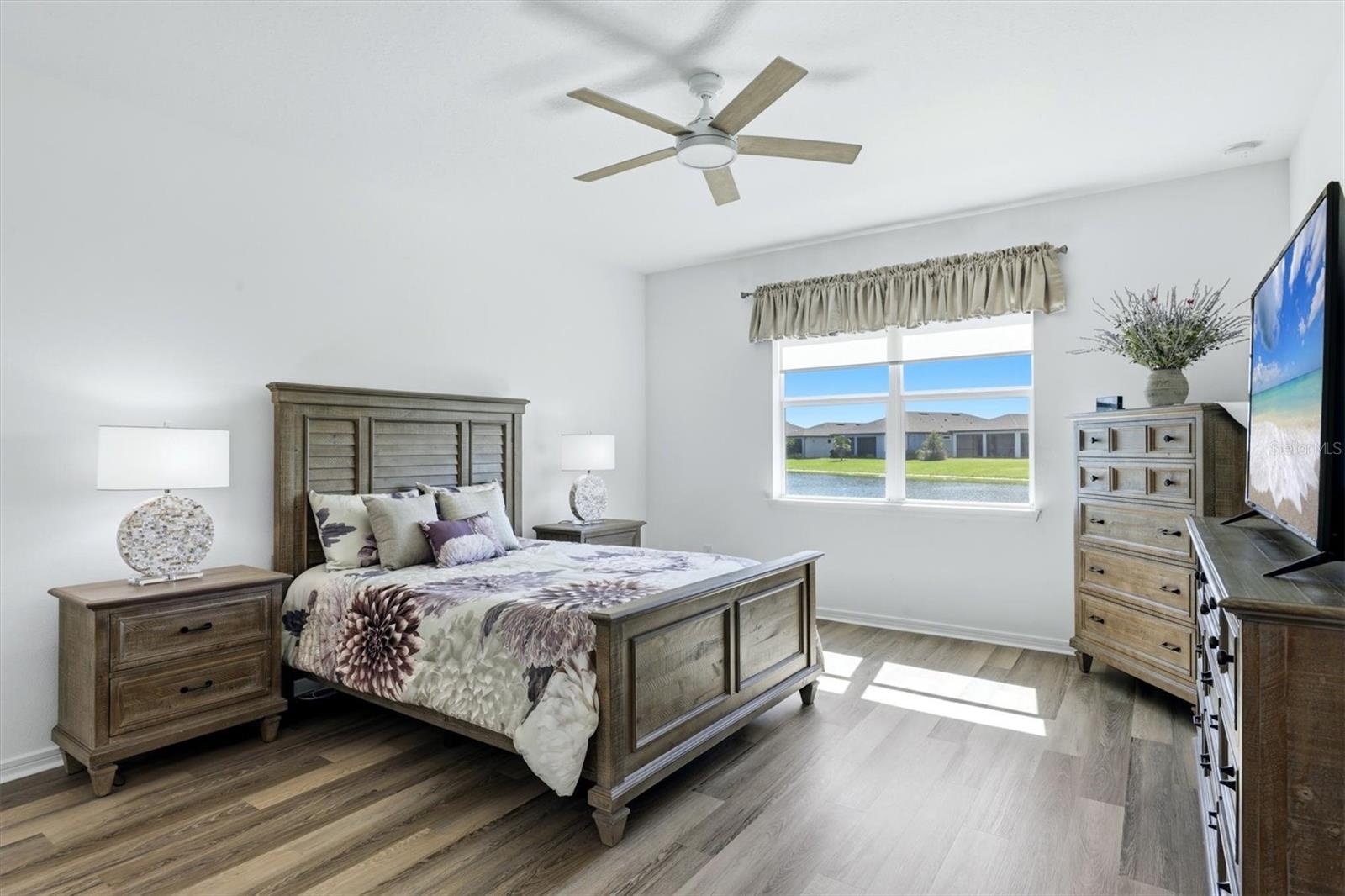 Primary Suite with pond view. Very spacious with newer LPV flooring.