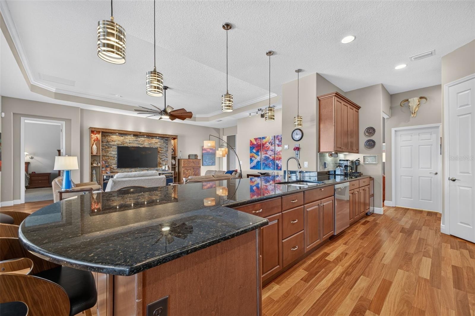 An expansive kitchen peninsula provides generous prep space, perfect for baking, meal prep, or entertaining.