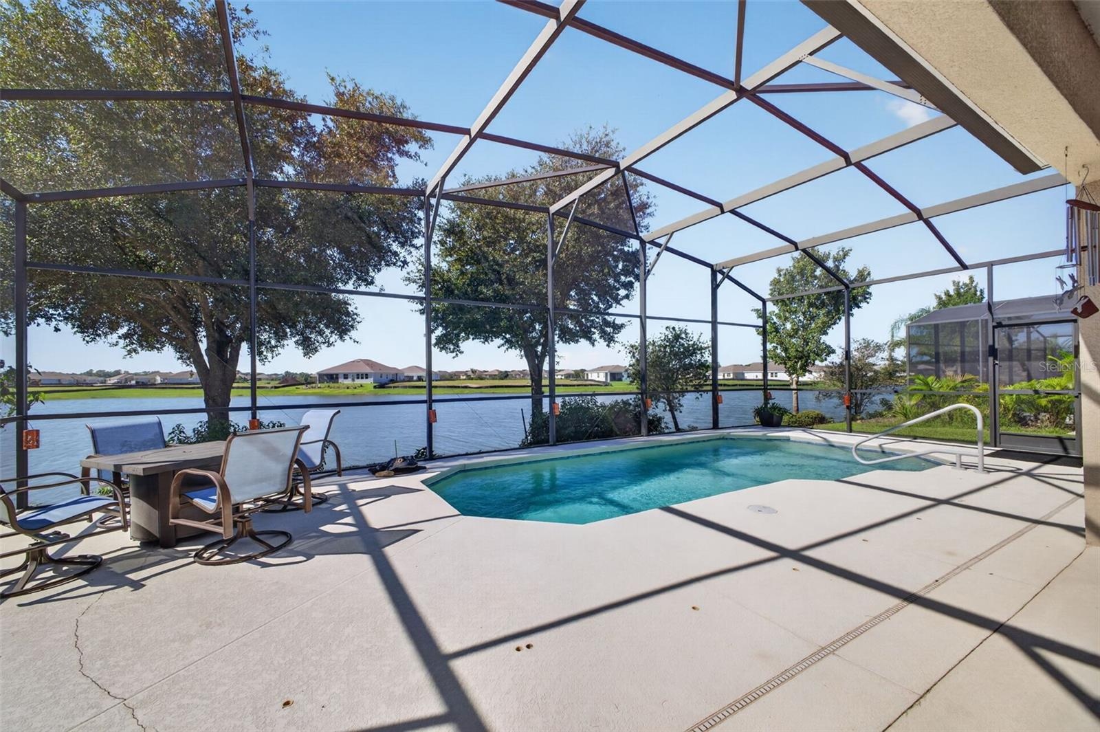 A sparkling pool set against scenic lake views creates the ultimate outdoor oasis for relaxation and entertaining.