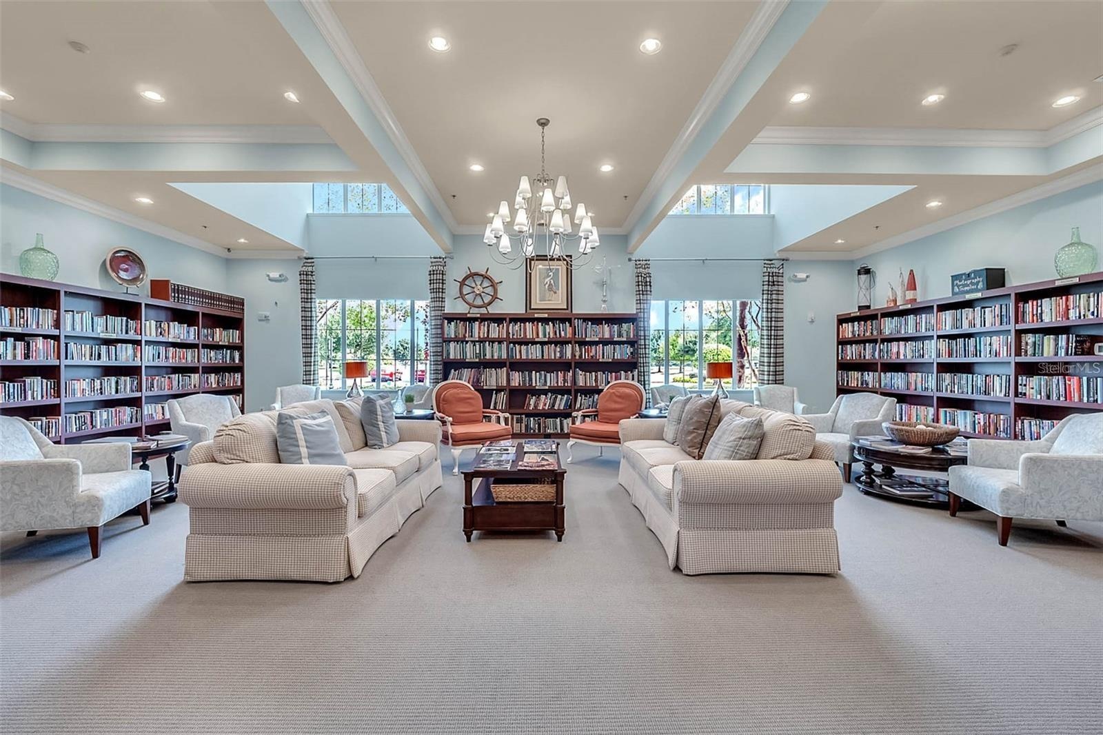 The community library offers a quiet, sunlit retreat complete with cozy seating and a rich collection of books for resident enjoyment.
