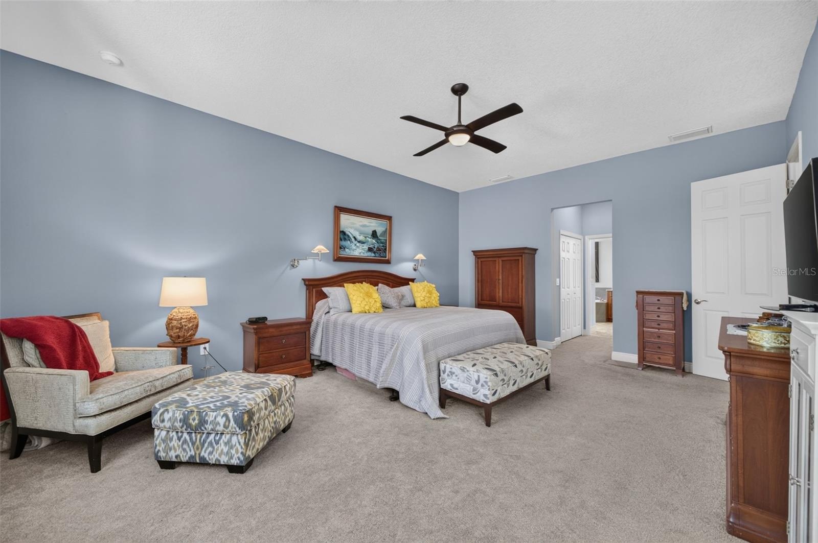 A serene sanctuary, this sunlit primary retreat offers expansive dual walk-in closets and an exquisite, spa-inspired en-suite bathroom.