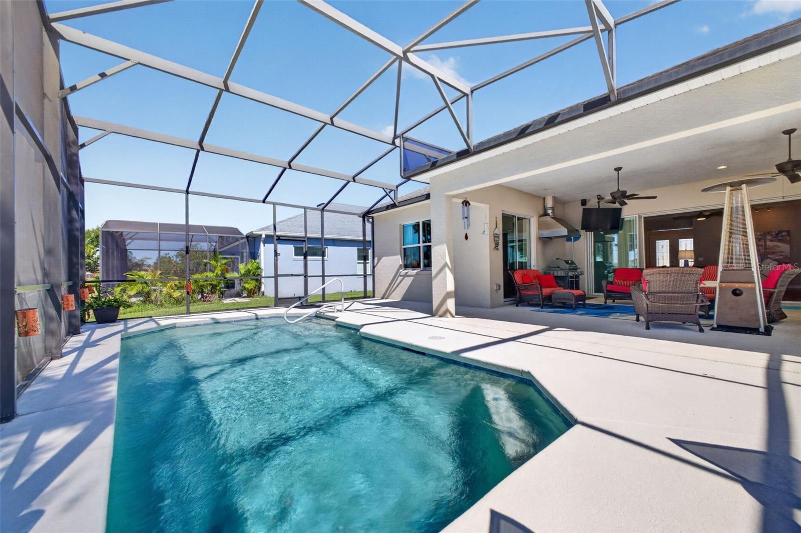 A screened pool cage offers easy, low-maintenance living for the generous 23' x 13' swimming pool.