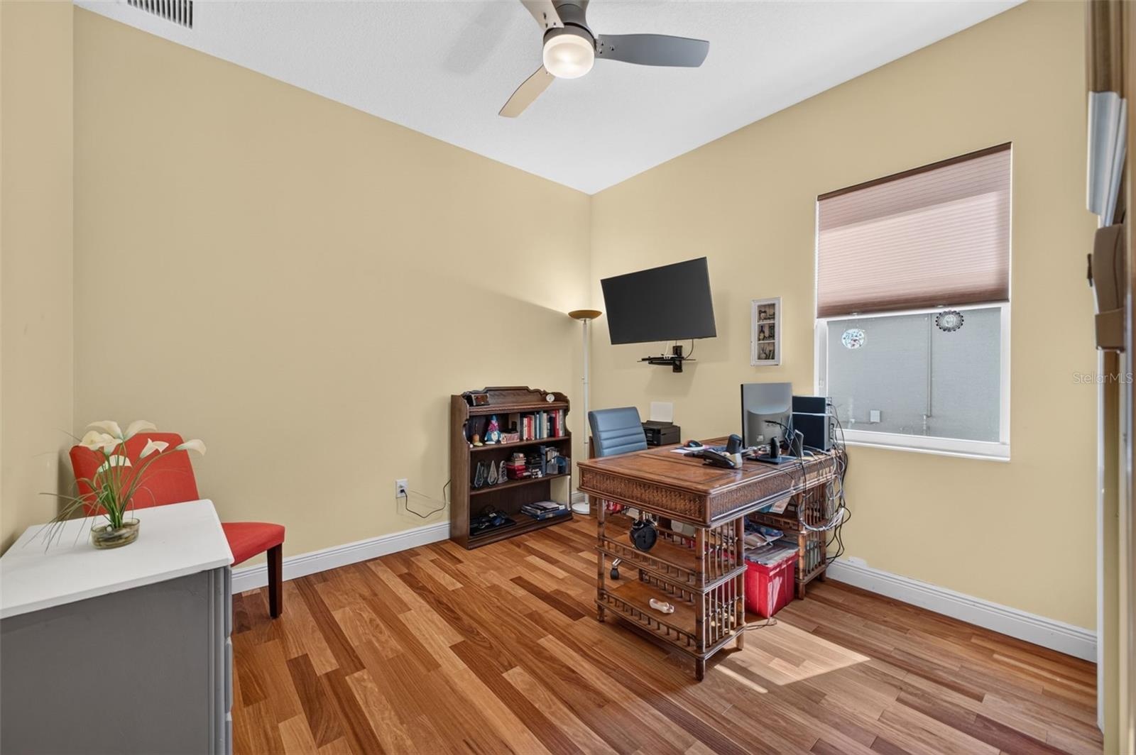 Offering versatile living space, the second bedroom functions beautifully as a quiet home office or a spacious guest retreat.