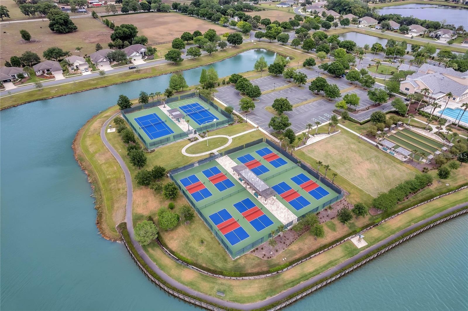The community features a championship-grade sports complex equipped with tennis, pickleball, and manicured croquet lawns for year-round play.