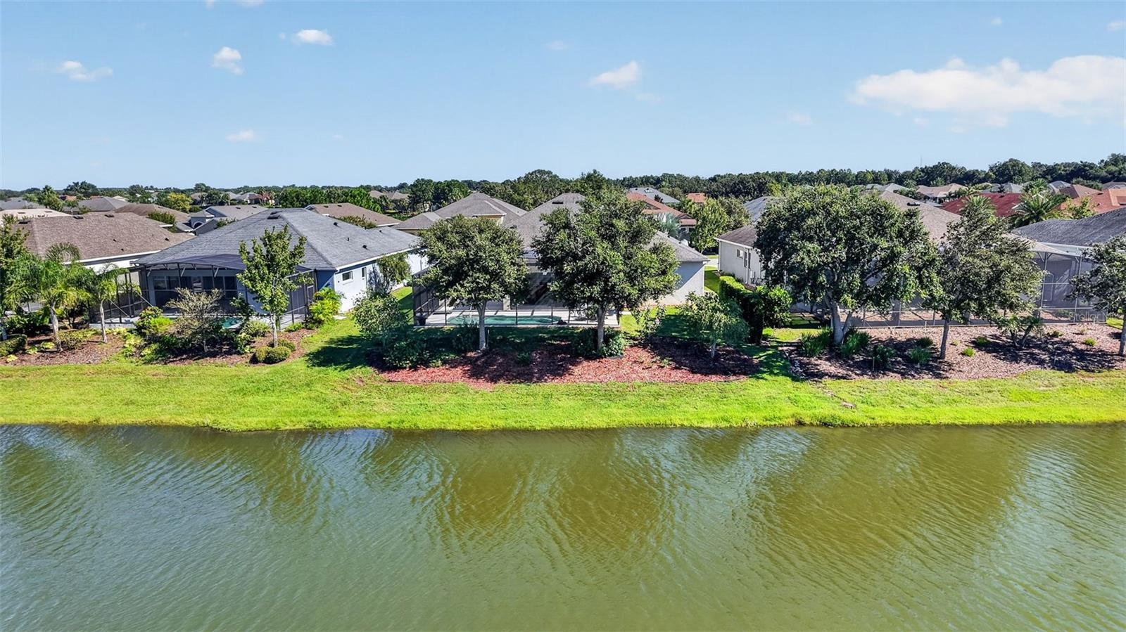 Mature oak trees line the rear of the property, providing natural shade and added privacy.
