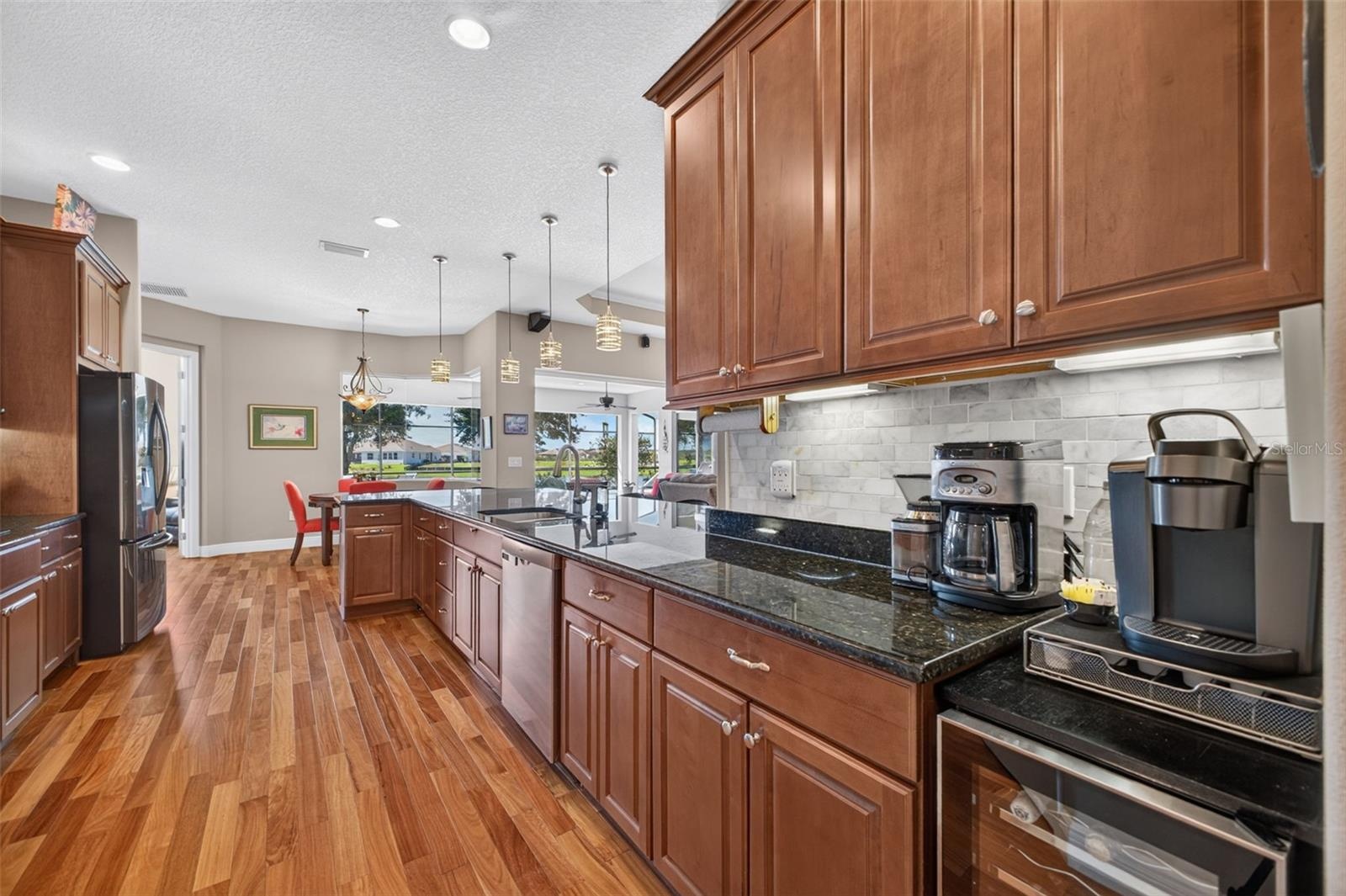 Under-cabinet lighting adds both warm atmosphere and practical task illumination to the workspace.