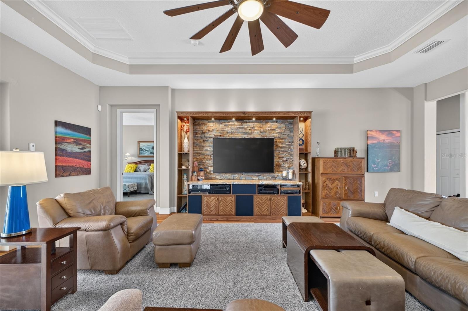 Sophisticated 11-foot coffered ceilings and an expansive open floor plan anchor this light-filled great room.