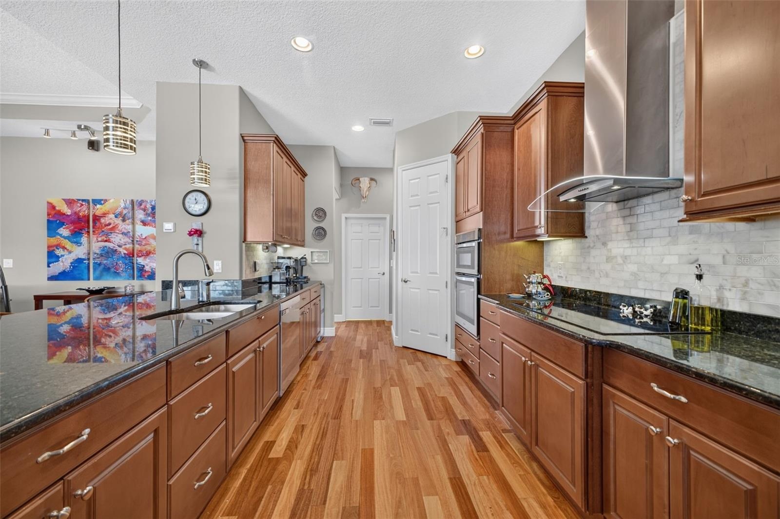 The beautifully appointed kitchen opens conveniently to a walk-in pantry and a dedicated indoor laundry room.