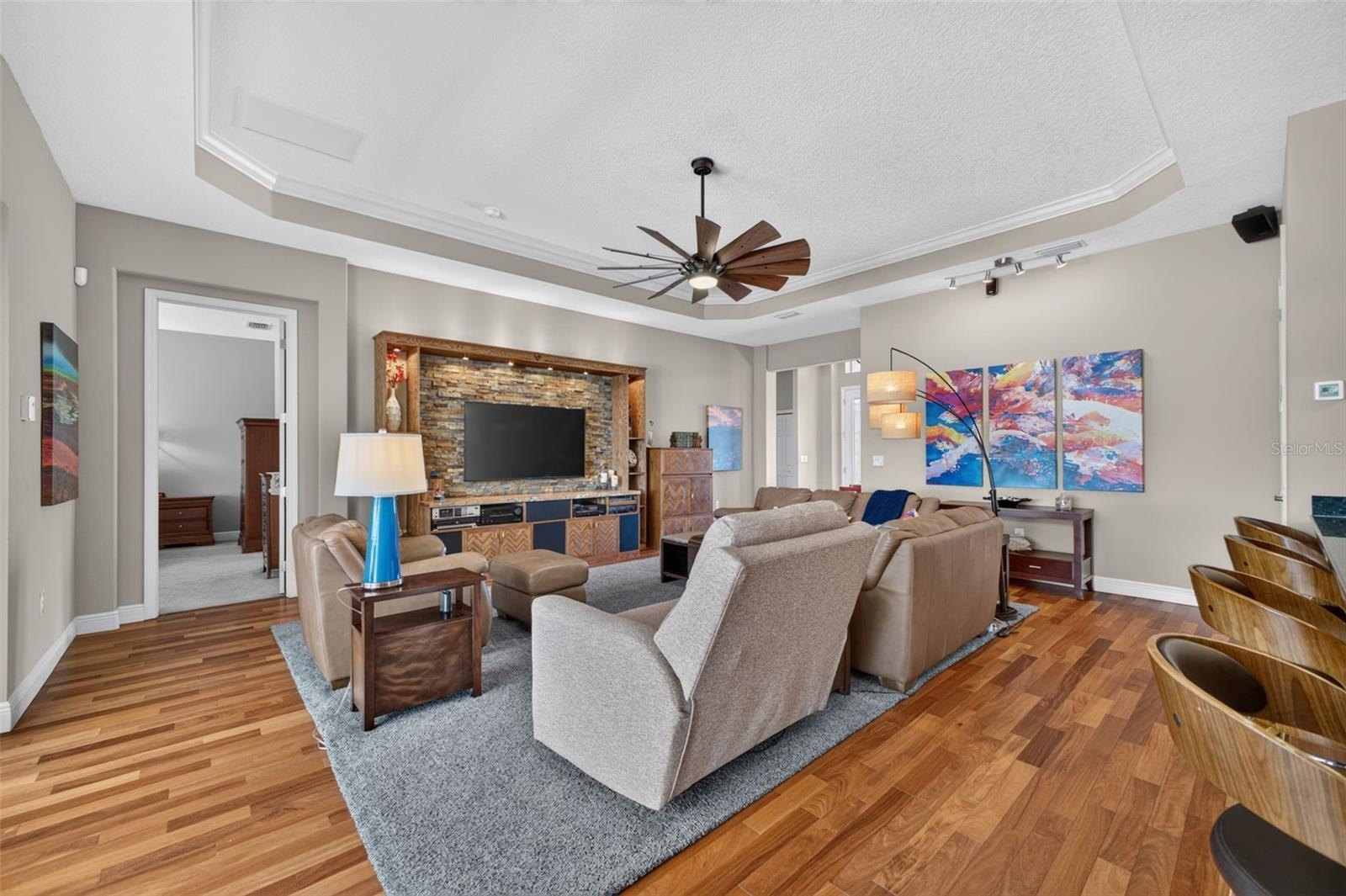 Stunning Brazilian Teak engineered hardwood flooring adds incredible depth and elegance to the spacious great room.