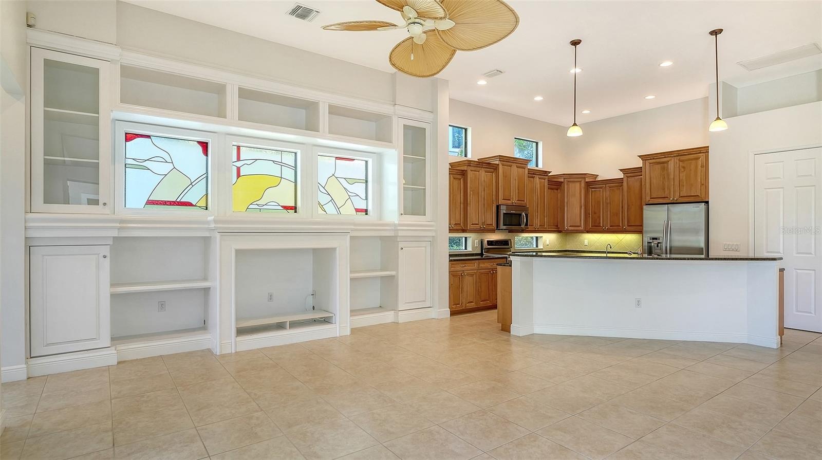 Tons of natural light in the great room and kitchen with transom windows and high soaring ceilings