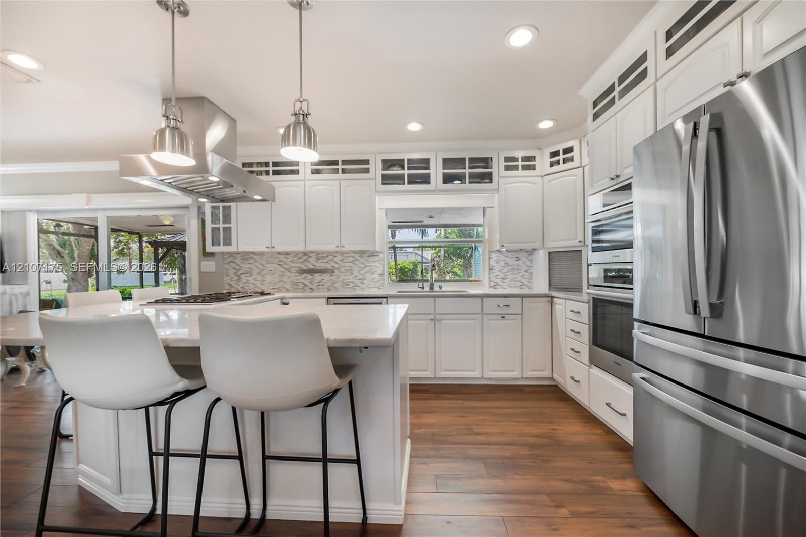 Professional grade stainless steel hood, gas stovetop and Bosch appliances.