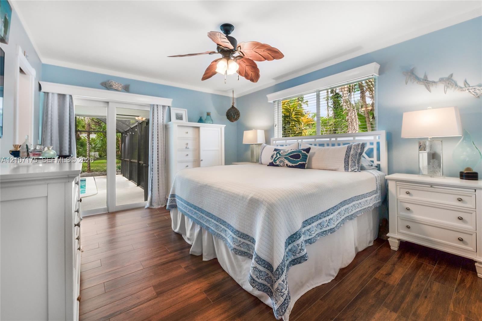 Beautiful sanctuary has expansive window with natural illumination and sliding door with access to pool.