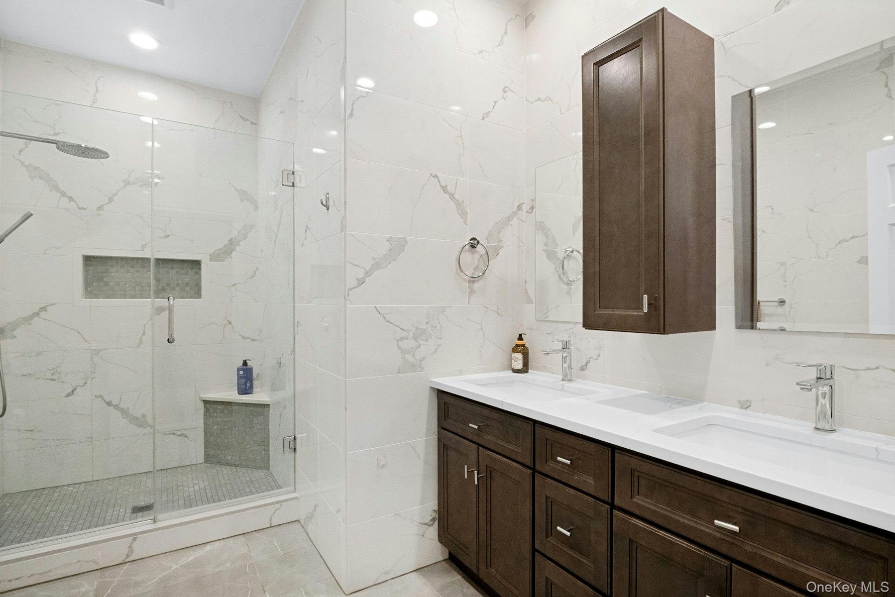 Hall spa-inspired bathroom with double sinks.