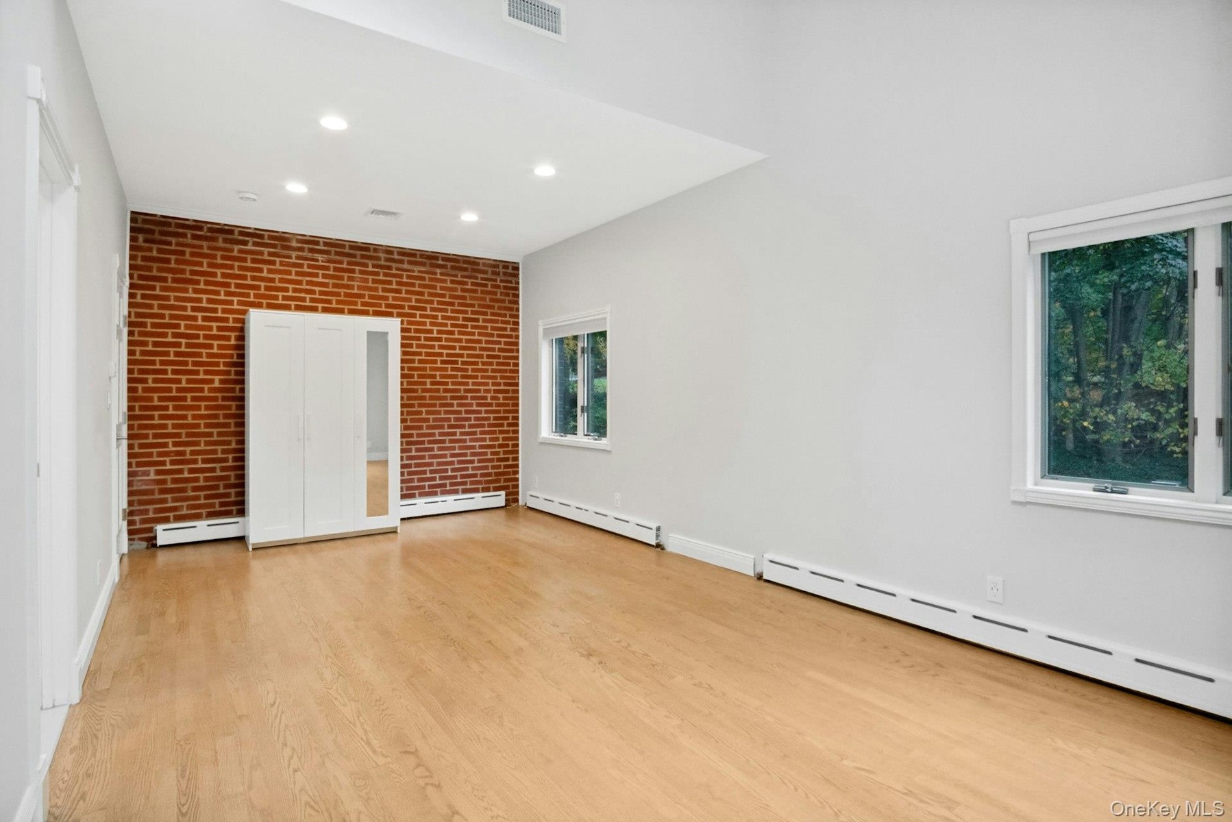 Primary bedroom with wood floors.