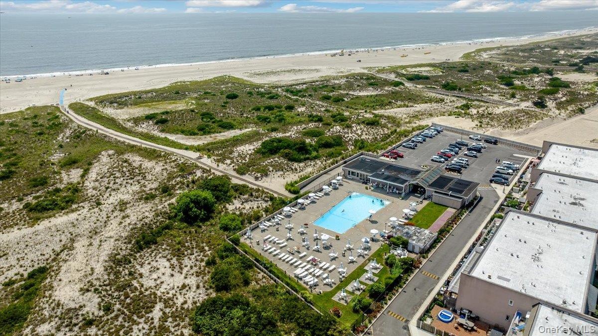 Aerial view featuring a water view and a view of the beach