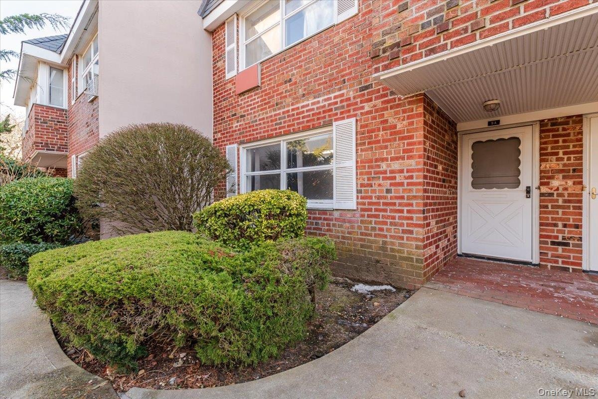 Doorway to property featuring brick siding