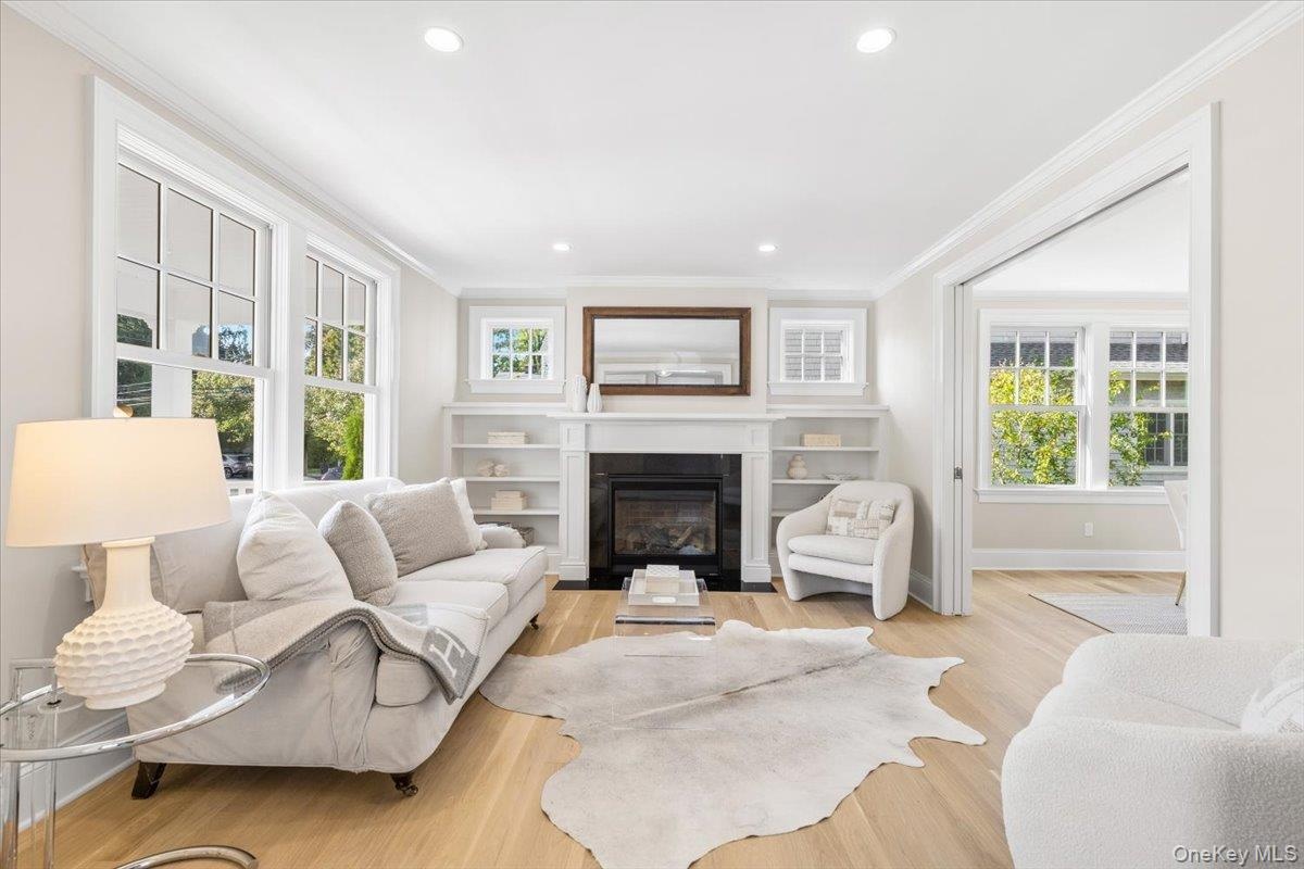 This living room sets the quality throughout the home from the custom built-ins, custom square transom windows distinctive custom detail, gas fireplac