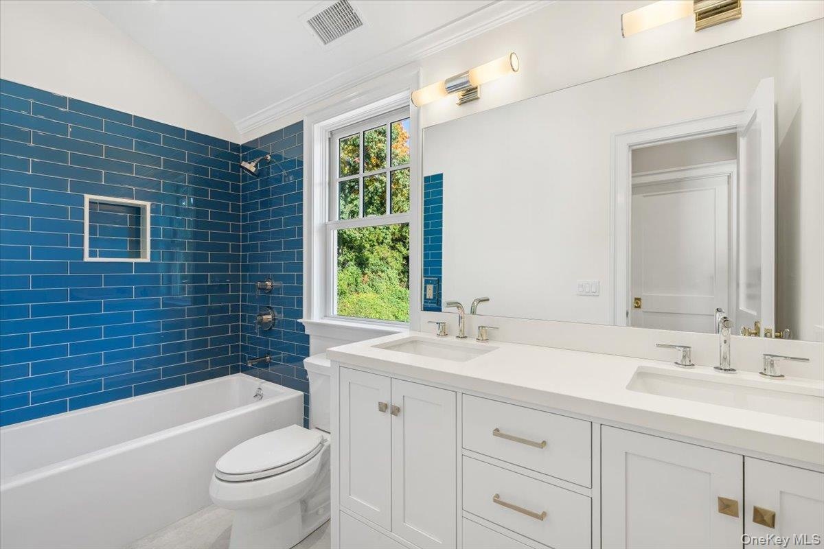 Second floor hall bathroom features dual vanity
