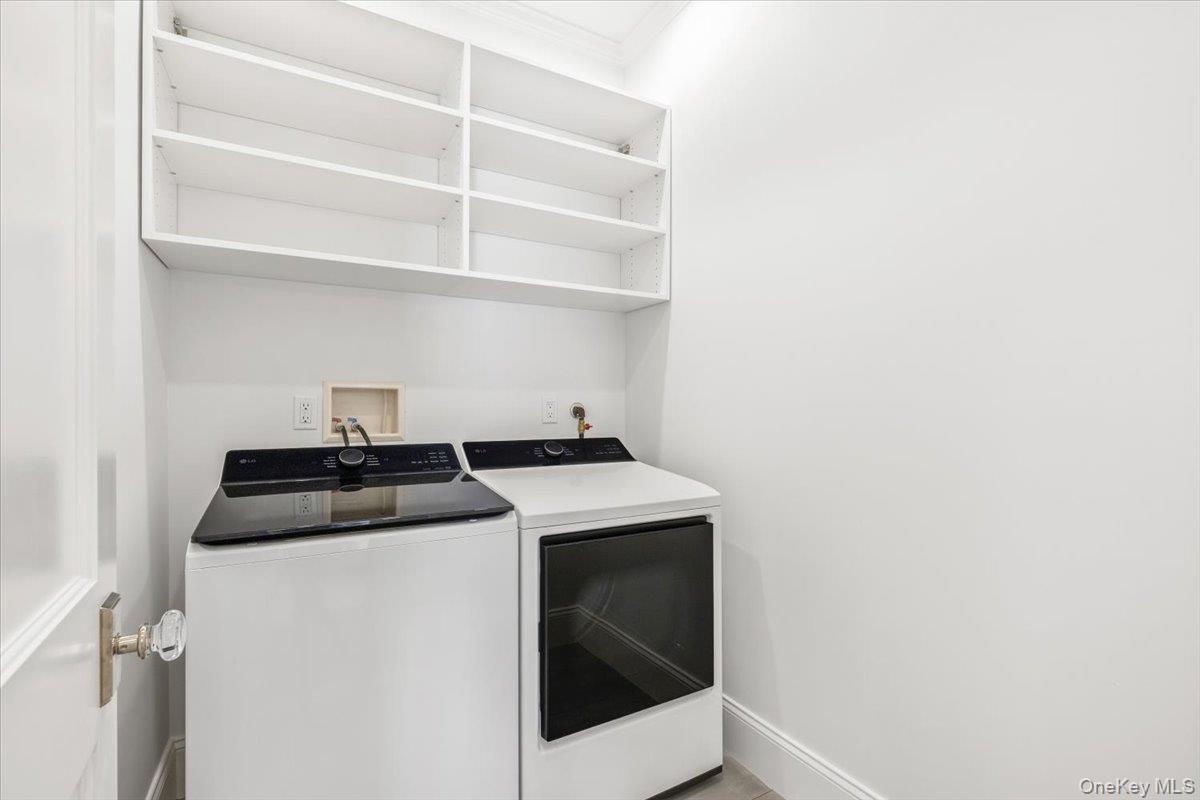 Large second floor laundry room offering excellent work space, additional storage.