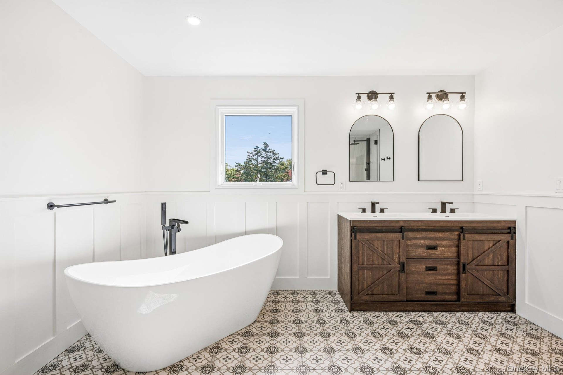 A freestanding tub beneath the window for long, unhurried soaks, the perfect close to afternoon tea at the Mad Batter Tea Room on Montauk Highway, abo