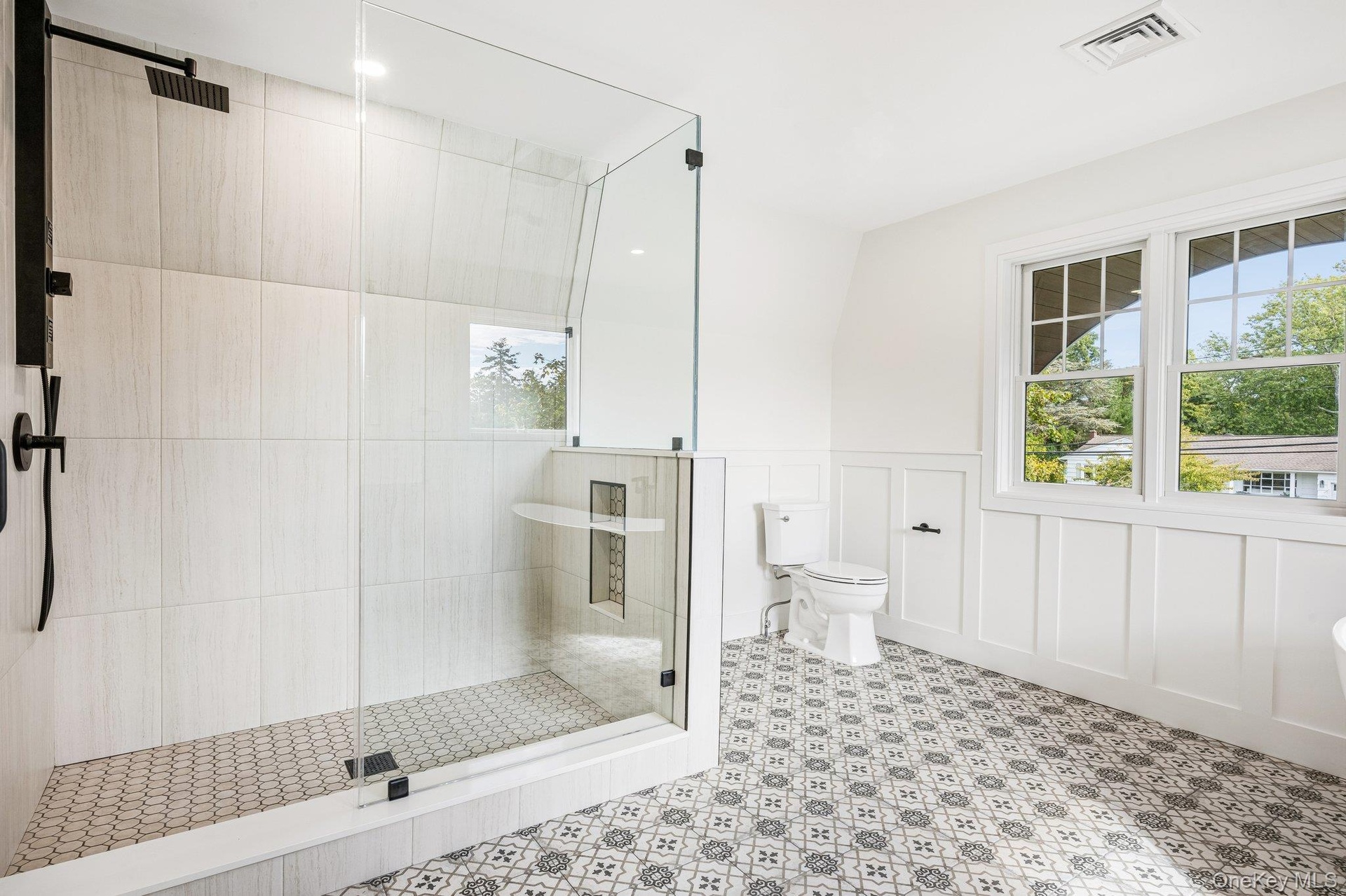 A frameless glass shower in the primary bath. Rinse off after a paddle from the Blue Point Dock, under half a mile away, then lunch at Flo's Luncheone