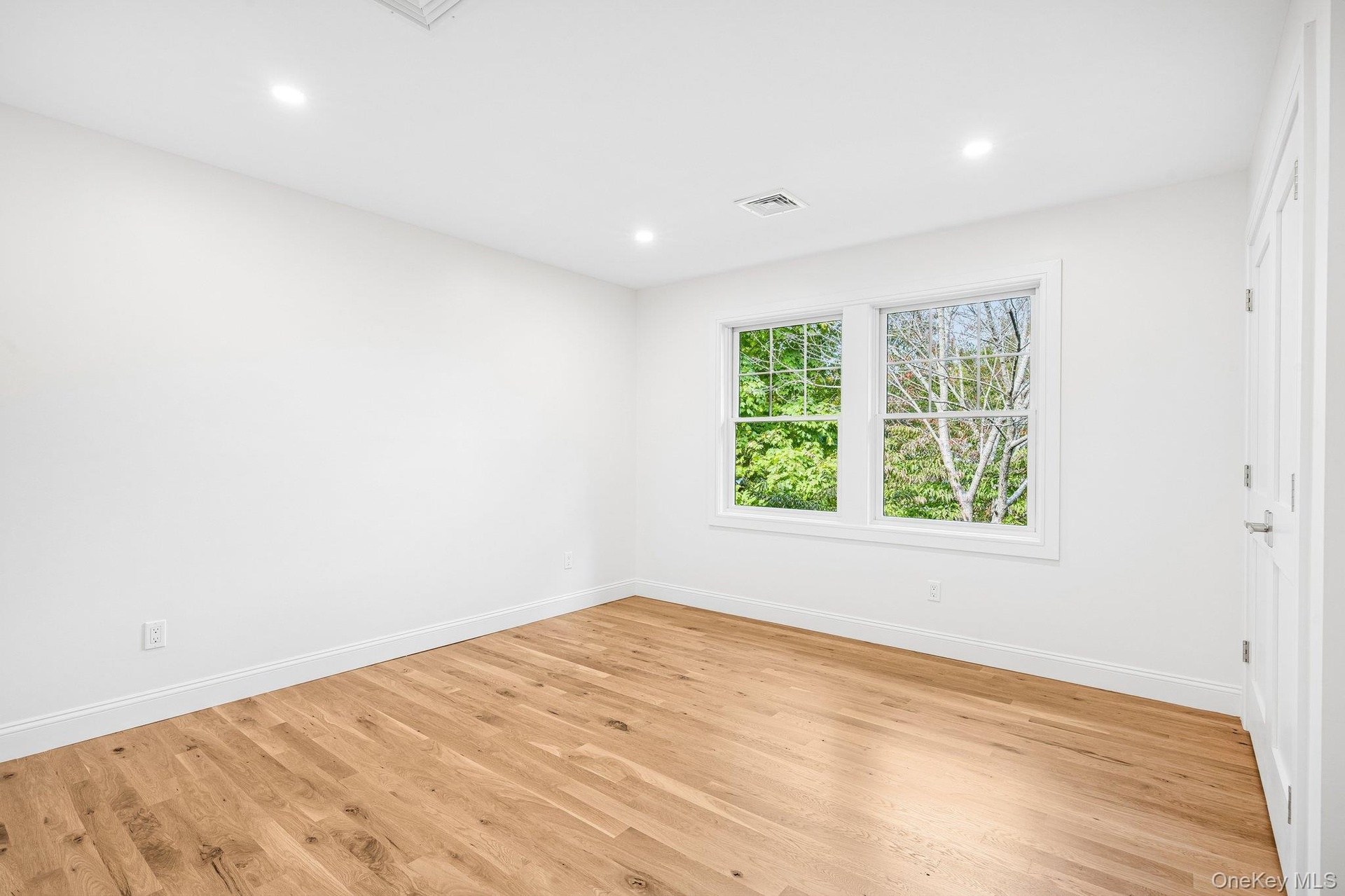 Soft light and wide-plank floors in another generous bedroom. Take-out night means empanadas and tostones from Tico's Empanadas, about half a mile awa