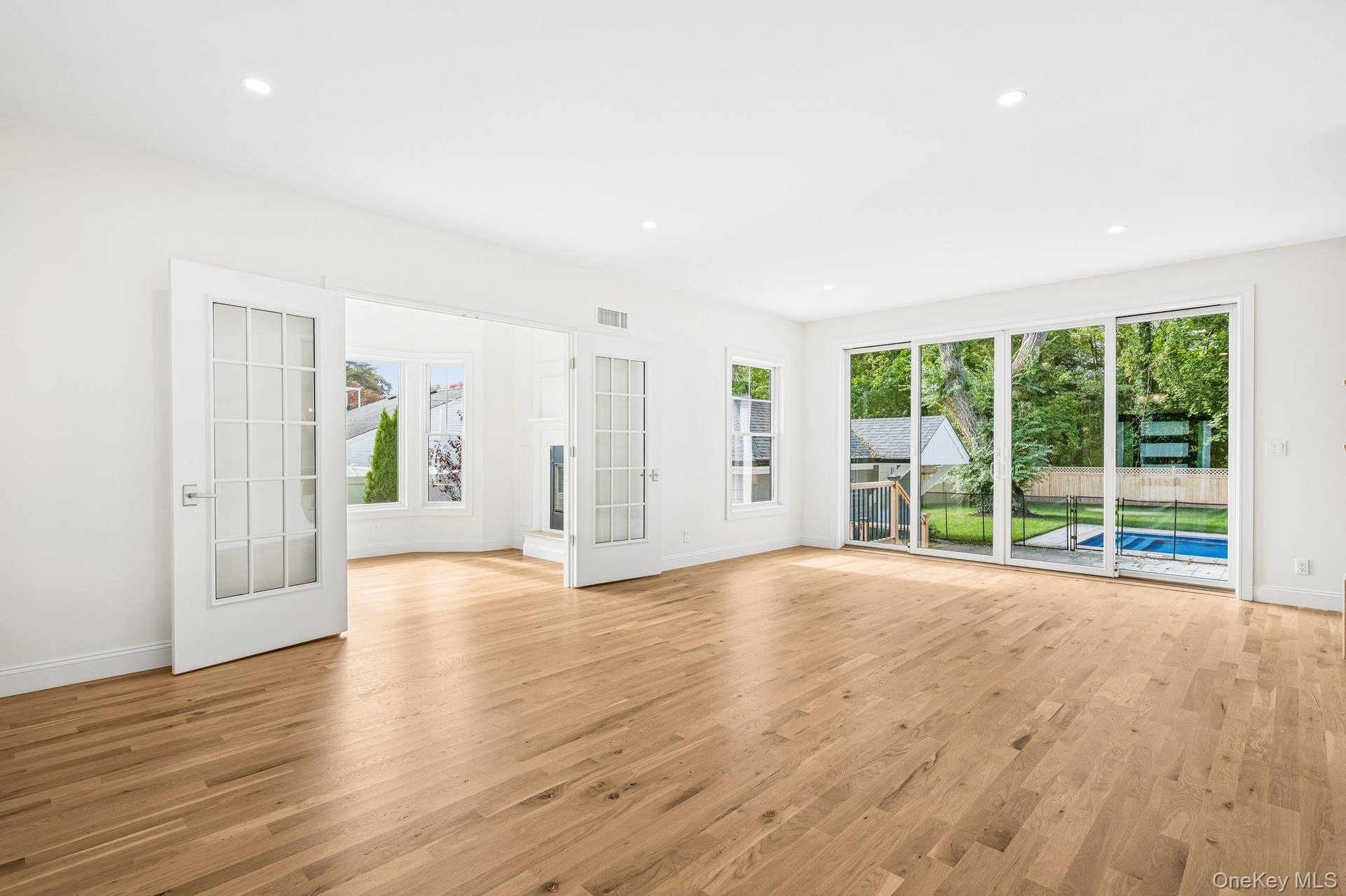 An open great room with warm oak-tone floors. Mid-morning, the Nature Preserve at the end of Nelson Avenue offers paved loops you can enjoy in 30 to 6