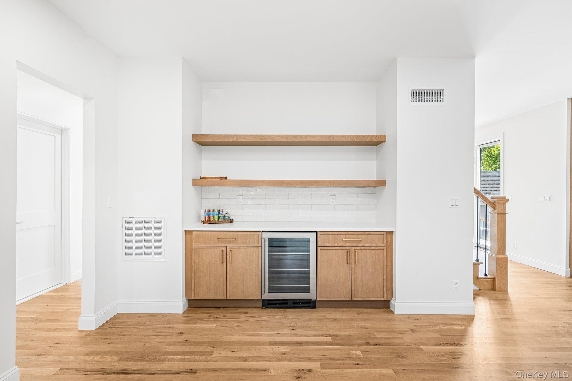 Dining room built-ins with built in wine fridge for effortless entertaining. After dessert, a sunset stroll to the Blue Point Dock on the Great South 